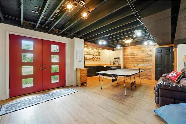 15376 Loring Rd, Bonner Springs, KS 66012 - game room featuring light wood-style floors, wood walls, and bar