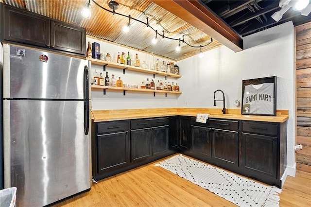 15376 Loring Rd, Bonner Springs, KS 66012 - kitchen featuring freestanding refrigerator, wood counters, light wood-style flooring, open shelves, and wood walls