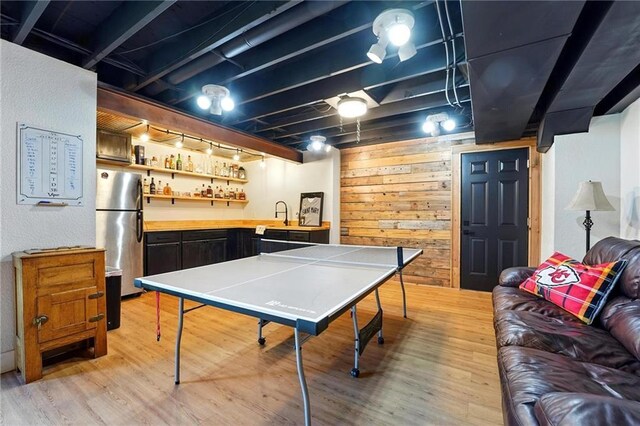15376 Loring Rd, Bonner Springs, KS 66012 - rec room featuring light wood-type flooring, bar area, and wooden walls
