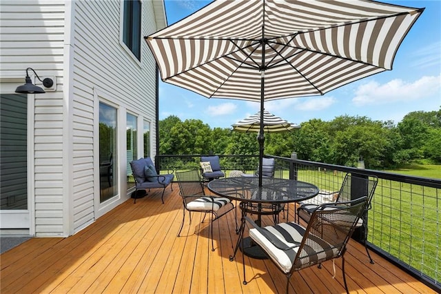15376 Loring Rd, Bonner Springs, KS 66012 - wooden deck featuring outdoor dining space and a lawn
