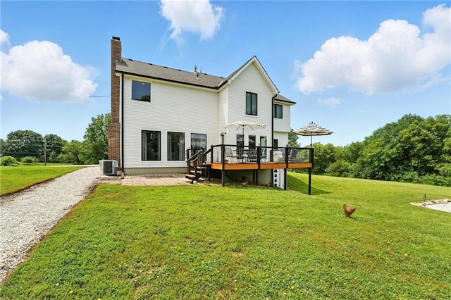 15376 Loring Rd, Bonner Springs, KS 66012 - back of property featuring a wooden deck, a chimney, a lawn, and a patio area