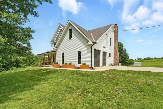 15376 Loring Rd, Bonner Springs, KS 66012 - view of side of property with a chimney, concrete driveway, and a lawn