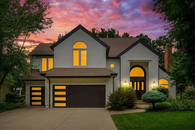 8148 Lingle Ln, Lenexa, KS 66215 - traditional-style house with stucco siding, a garage, driveway, french doors, and a shingled roof