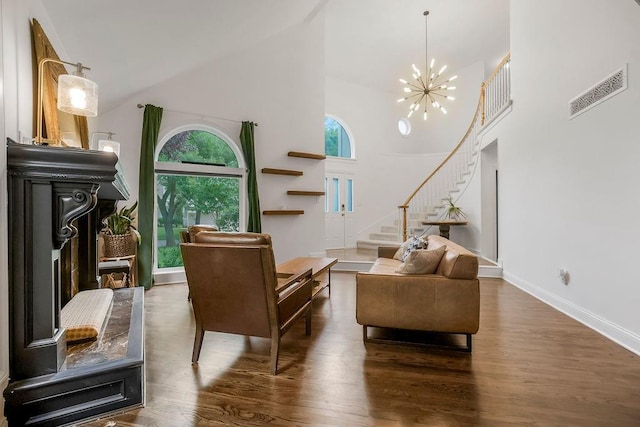 8148 Lingle Ln, Lenexa, KS 66215 - living area featuring high vaulted ceiling, stairway, wood finished floors, and a chandelier