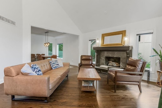8148 Lingle Ln, Lenexa, KS 66215 - living room with dark wood finished floors, high vaulted ceiling, a premium fireplace, and a chandelier