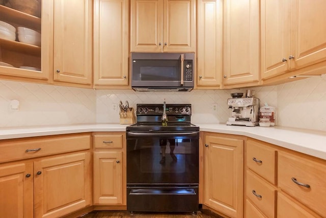 8148 Lingle Ln, Lenexa, KS 66215 - kitchen with black range with electric stovetop, tasteful backsplash, light countertops, and glass insert cabinets
