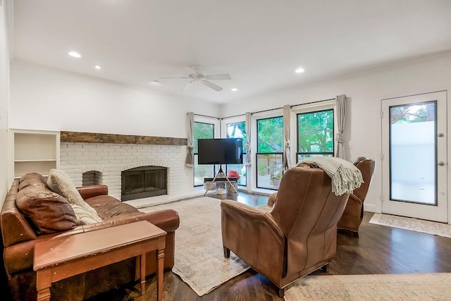 8148 Lingle Ln, Lenexa, KS 66215 - living room featuring a ceiling fan, wood finished floors, recessed lighting, and a brick fireplace
