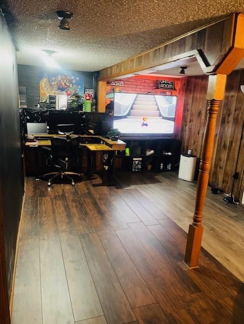 3119 Seneca St, Saint Joseph, MO 64507 - office space featuring hardwood / wood-style flooring, wood walls, and a textured ceiling