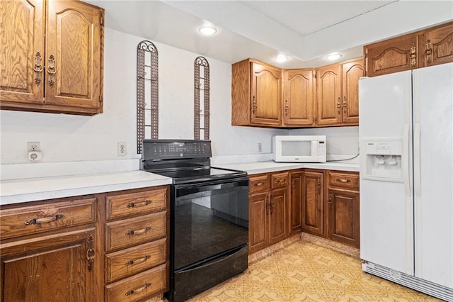4445 NW 52nd Ter, Topeka, KS 66618 - kitchen featuring white appliances, recessed lighting, brown cabinets, and light countertops