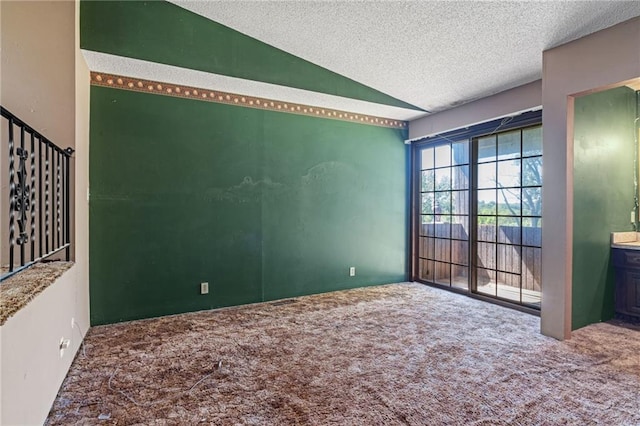 4445 NW 52nd Ter, Topeka, KS 66618 - empty room featuring carpet flooring, lofted ceiling, and a textured ceiling
