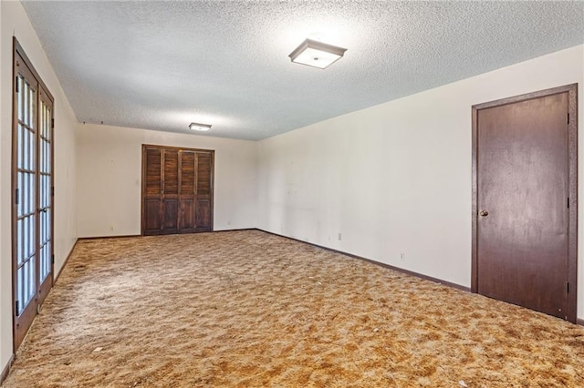 4445 NW 52nd Ter, Topeka, KS 66618 - unfurnished bedroom featuring a textured ceiling, carpet floors, and a closet
