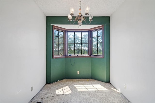 4445 NW 52nd Ter, Topeka, KS 66618 - carpeted spare room with a chandelier and a textured ceiling