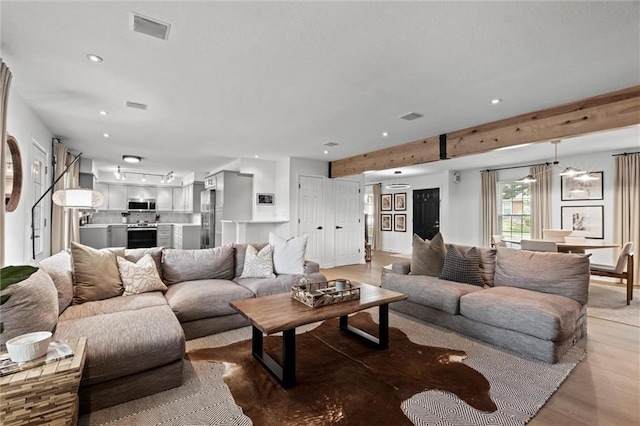 12005 W 100th Ter, Lenexa, KS 66215 - living area featuring recessed lighting, beam ceiling, and light wood-style floors