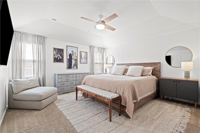 12005 W 100th Ter, Lenexa, KS 66215 - bedroom featuring a ceiling fan, lofted ceiling, light carpet, and a tray ceiling