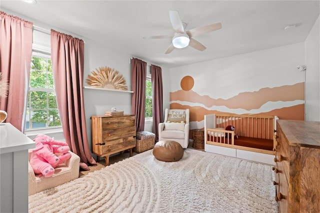 12005 W 100th Ter, Lenexa, KS 66215 - bedroom featuring multiple windows and a ceiling fan