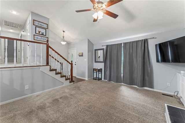 1275 NE Tudor Rd, Lees Summit, MO 64086 - unfurnished living room featuring a ceiling fan, carpet flooring, vaulted ceiling, and stairway