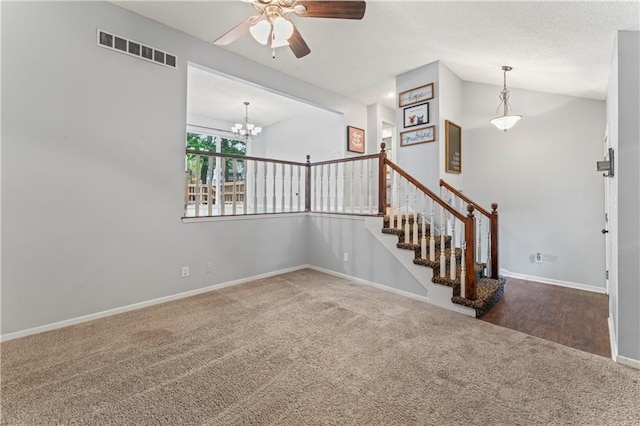 1275 NE Tudor Rd, Lees Summit, MO 64086 - staircase with carpet floors, ceiling fan, a chandelier, and vaulted ceiling
