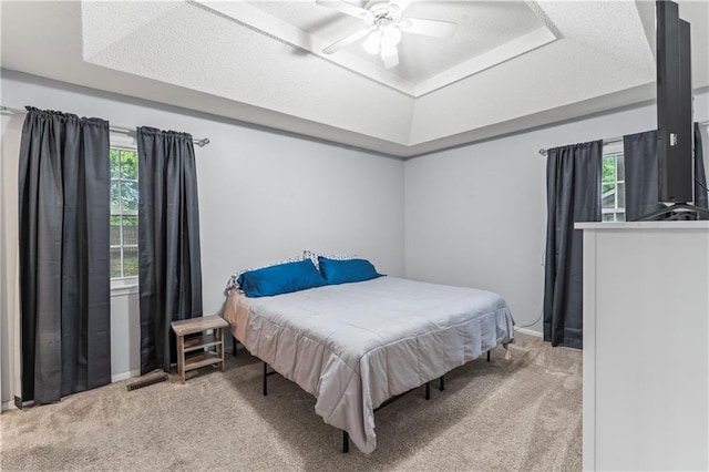 1275 NE Tudor Rd, Lees Summit, MO 64086 - carpeted bedroom with a raised ceiling and ceiling fan