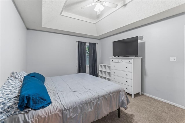 1275 NE Tudor Rd, Lees Summit, MO 64086 - carpeted bedroom featuring a raised ceiling and ceiling fan