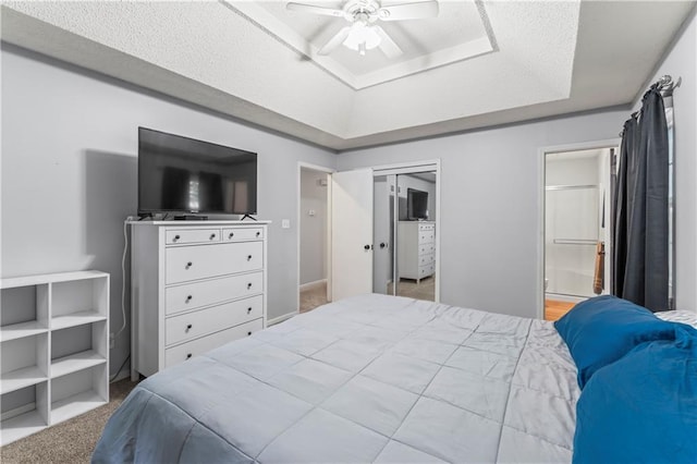 1275 NE Tudor Rd, Lees Summit, MO 64086 - carpeted bedroom with a raised ceiling, ensuite bath, ceiling fan, and a closet