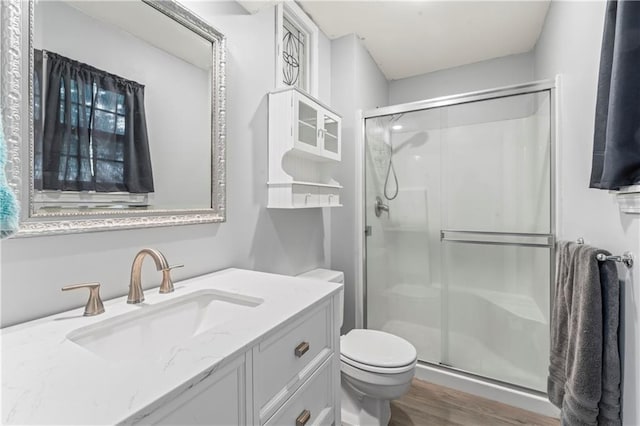 1275 NE Tudor Rd, Lees Summit, MO 64086 - bathroom with a shower stall, wood finished floors, and vanity