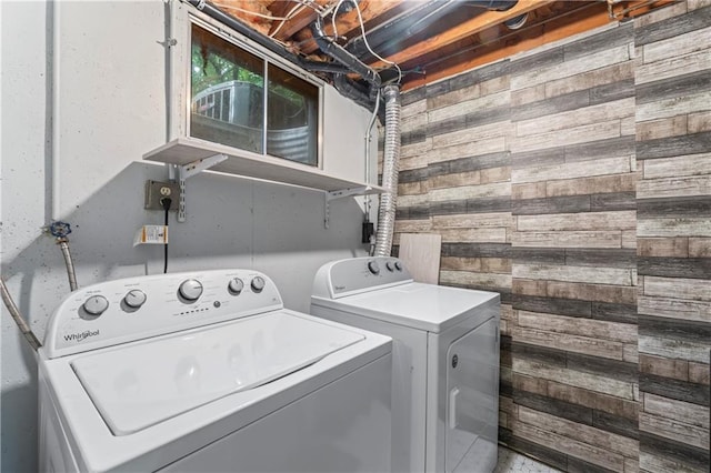 1275 NE Tudor Rd, Lees Summit, MO 64086 - laundry room featuring wooden walls and separate washer and dryer