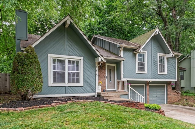 1275 NE Tudor Rd, Lees Summit, MO 64086 - view of front of home with an attached garage, driveway, and brick siding