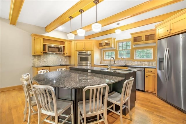 245 SW 400th Rd, Warrensburg, MO 64093 - kitchen featuring appliances with stainless steel finishes, beam ceiling, a center island with sink, backsplash, and a kitchen bar