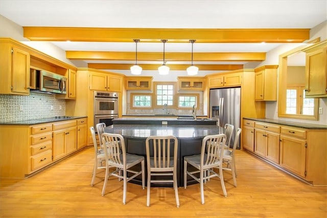 245 SW 400th Rd, Warrensburg, MO 64093 - kitchen with stainless steel appliances, a kitchen breakfast bar, beamed ceiling, decorative backsplash, and a kitchen island with sink