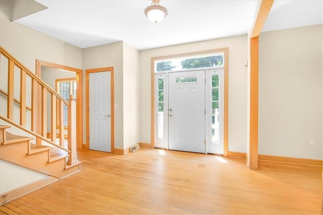 245 SW 400th Rd, Warrensburg, MO 64093 - foyer featuring light wood-style flooring and stairs
