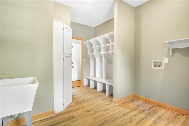 245 SW 400th Rd, Warrensburg, MO 64093 - washroom featuring light wood-type flooring and hookup for a washing machine
