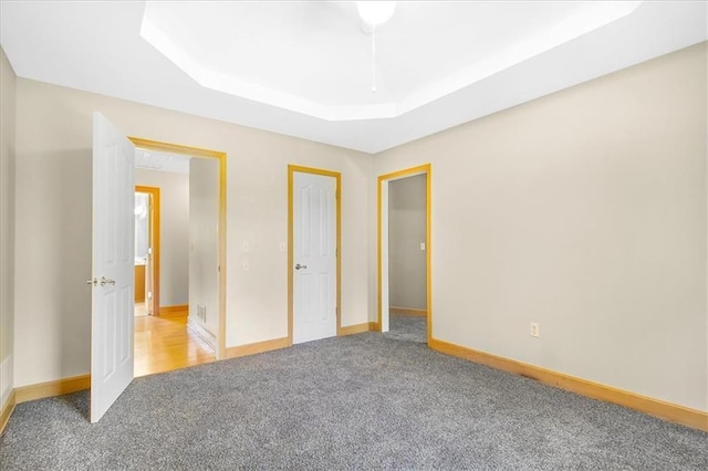 245 SW 400th Rd, Warrensburg, MO 64093 - unfurnished bedroom with carpet flooring and a raised ceiling