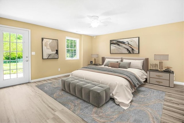 245 SW 400th Rd, Warrensburg, MO 64093 - bedroom featuring access to outside, wood finished floors, and ceiling fan