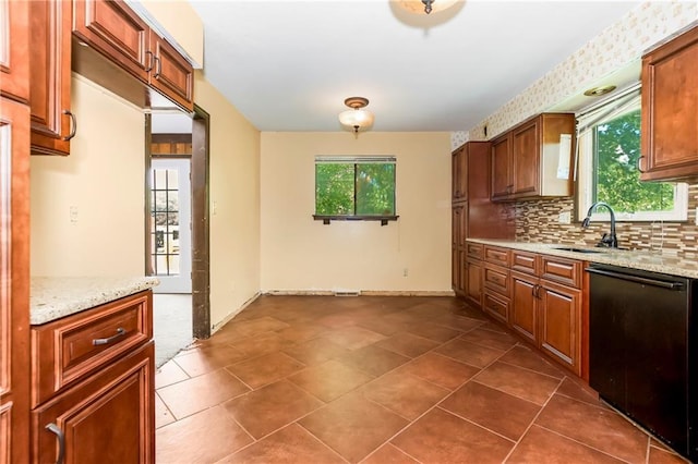 12417 Newton Ct, Grandview, MO 64030 - kitchen with black dishwasher, tasteful backsplash, light stone countertops, and brown cabinetry