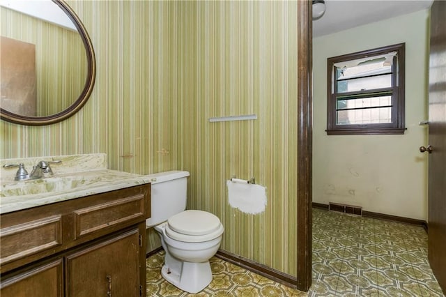 12417 Newton Ct, Grandview, MO 64030 - bathroom featuring vanity and wallpapered walls