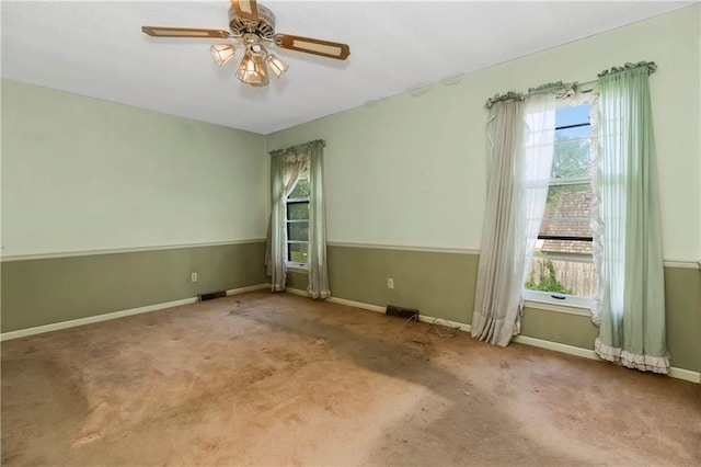 12417 Newton Ct, Grandview, MO 64030 - empty room with healthy amount of natural light, a ceiling fan, and carpet floors