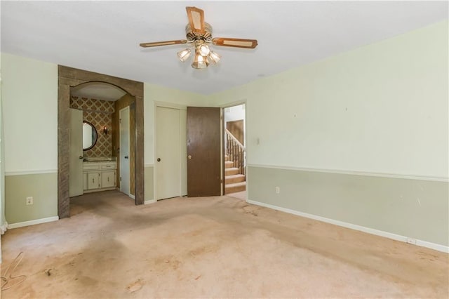 12417 Newton Ct, Grandview, MO 64030 - carpeted spare room featuring stairway and ceiling fan