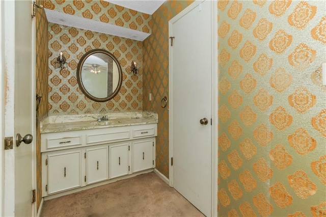 12417 Newton Ct, Grandview, MO 64030 - bathroom with wallpapered walls, vanity, and ceiling fan