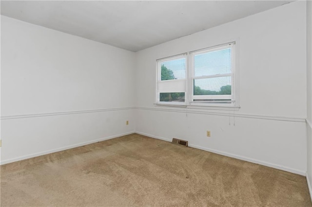12417 Newton Ct, Grandview, MO 64030 - spare room featuring carpet floors and baseboards