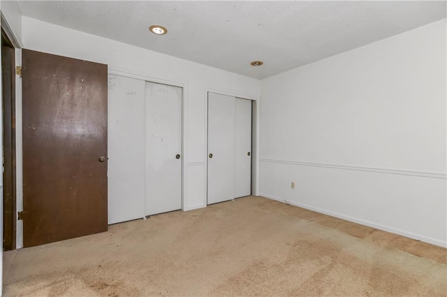 12417 Newton Ct, Grandview, MO 64030 - unfurnished bedroom with two closets and carpet flooring
