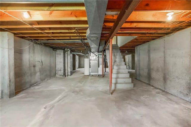 12417 Newton Ct, Grandview, MO 64030 - unfinished below grade area with stairway, heating unit, and gas water heater