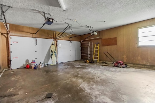 12417 Newton Ct, Grandview, MO 64030 - garage featuring a garage door opener and wooden walls