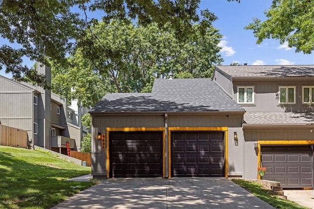 6628 Bradshaw St, Shawnee, KS 66216 - view of front facade with roof with shingles, driveway, and a garage