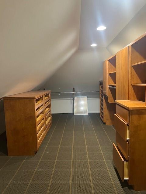 1901 NE River Ridge Rd, Saint Joseph, MO 64507 - additional living space featuring vaulted ceiling and dark colored carpet