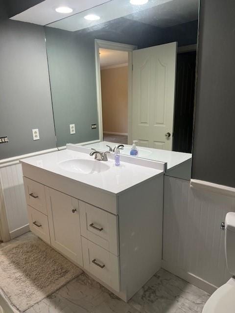 1901 NE River Ridge Rd, Saint Joseph, MO 64507 - bathroom with marble look tile flooring, wainscoting, and vanity
