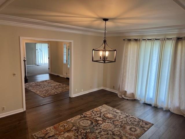 1901 NE River Ridge Rd, Saint Joseph, MO 64507 - unfurnished dining area featuring dark wood finished floors, ornamental molding, and a chandelier