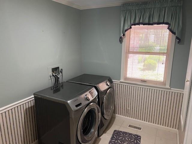 1901 NE River Ridge Rd, Saint Joseph, MO 64507 - washroom featuring a wainscoted wall, washing machine and dryer, tile patterned flooring, and crown molding