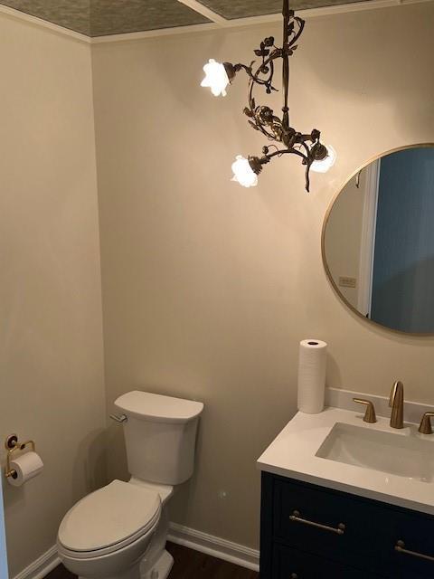 1901 NE River Ridge Rd, Saint Joseph, MO 64507 - bathroom featuring vanity, wood finished floors, and ornamental molding