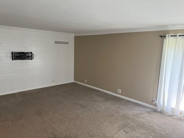 1901 NE River Ridge Rd, Saint Joseph, MO 64507 - unfurnished room featuring crown molding and dark carpet