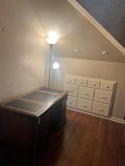 1901 NE River Ridge Rd, Saint Joseph, MO 64507 - unfurnished bedroom featuring dark wood finished floors and a textured wall